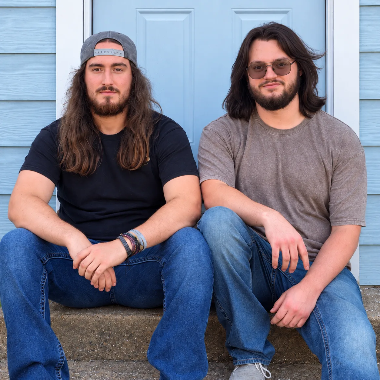 The C&S Home Help owners sitting together on blue porch steps